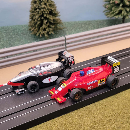 Micro Scalextric Pair 1:64 Cars - F1 Red Agip #28 & Black Mobil #9